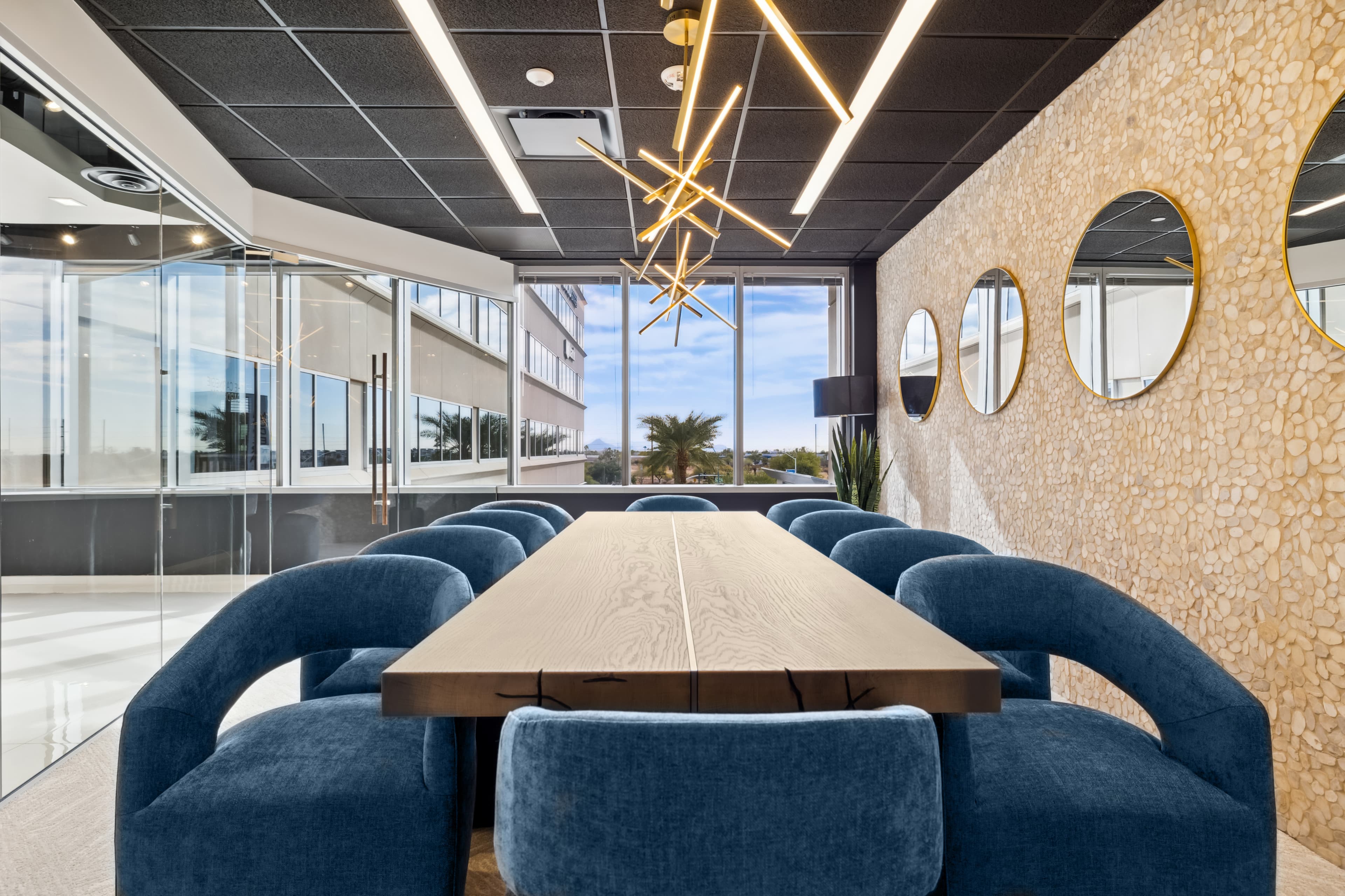 Meeting room with stimulating decor and large windows bringing in natural light at Lucid Private Offices in Scottsdale, AZ.
