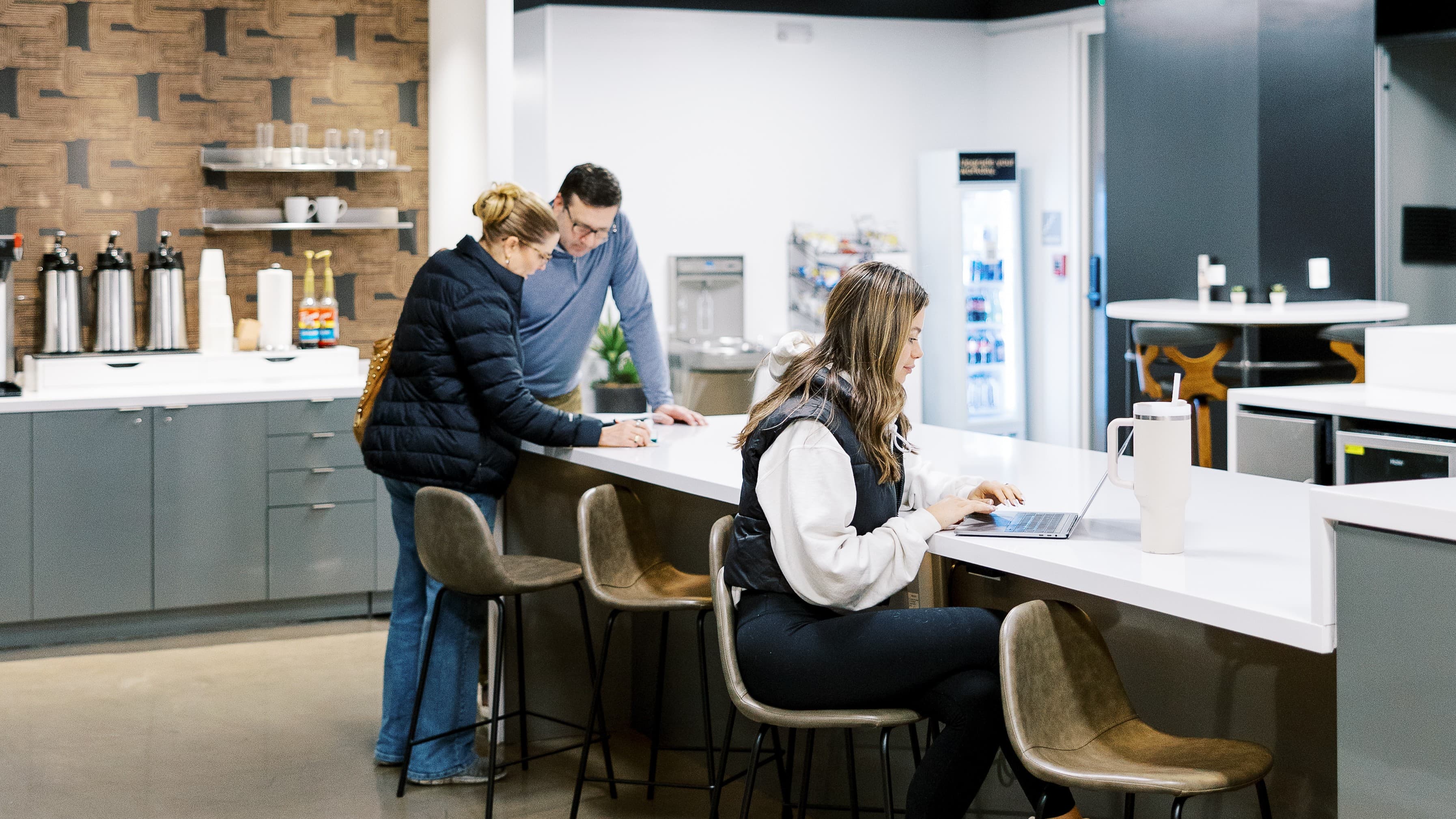 Three people in a coworking area at Lucid Private Offices