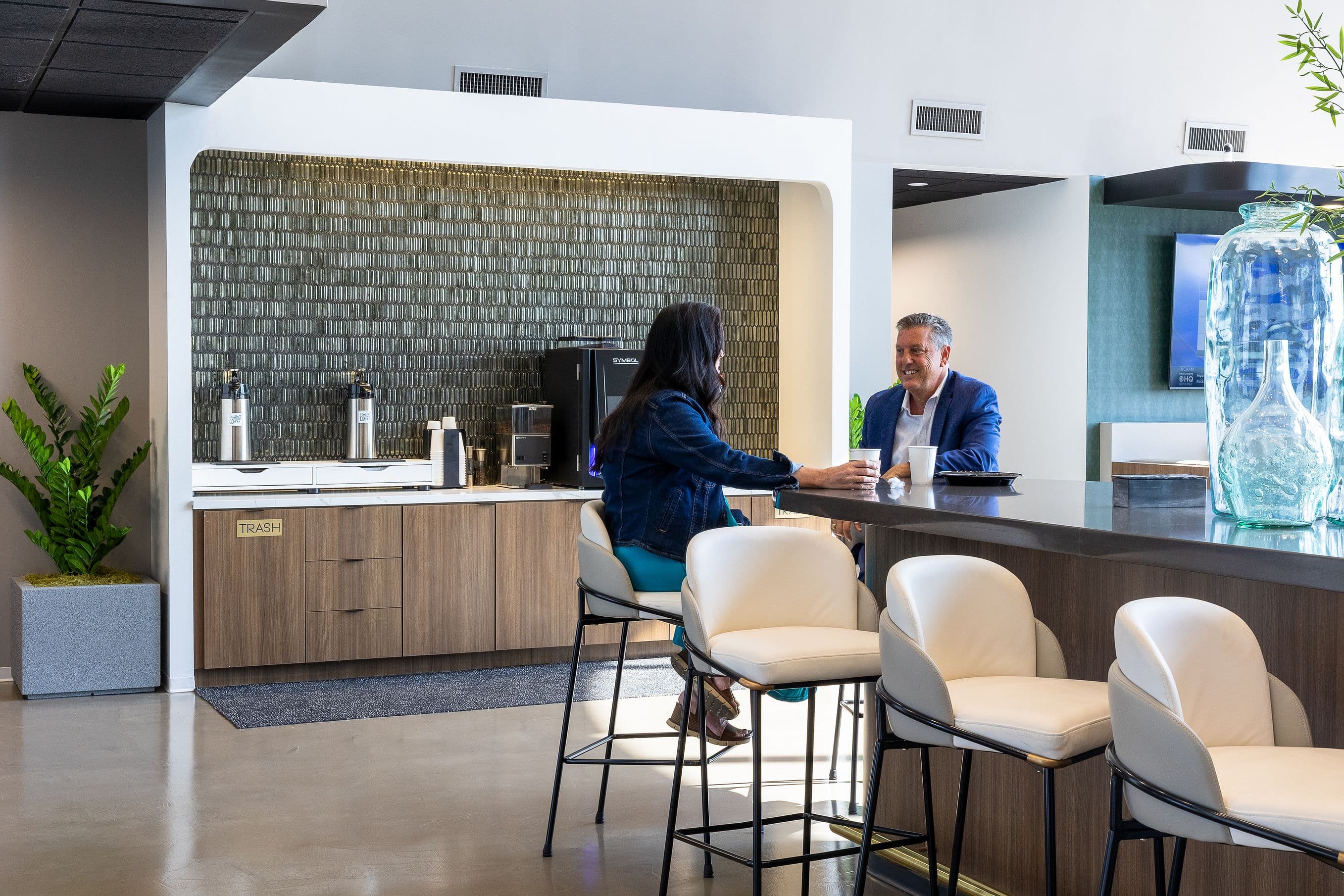 Two people working in the coffee lounge at Lucid Private Offices - Northpark / Central Expressway