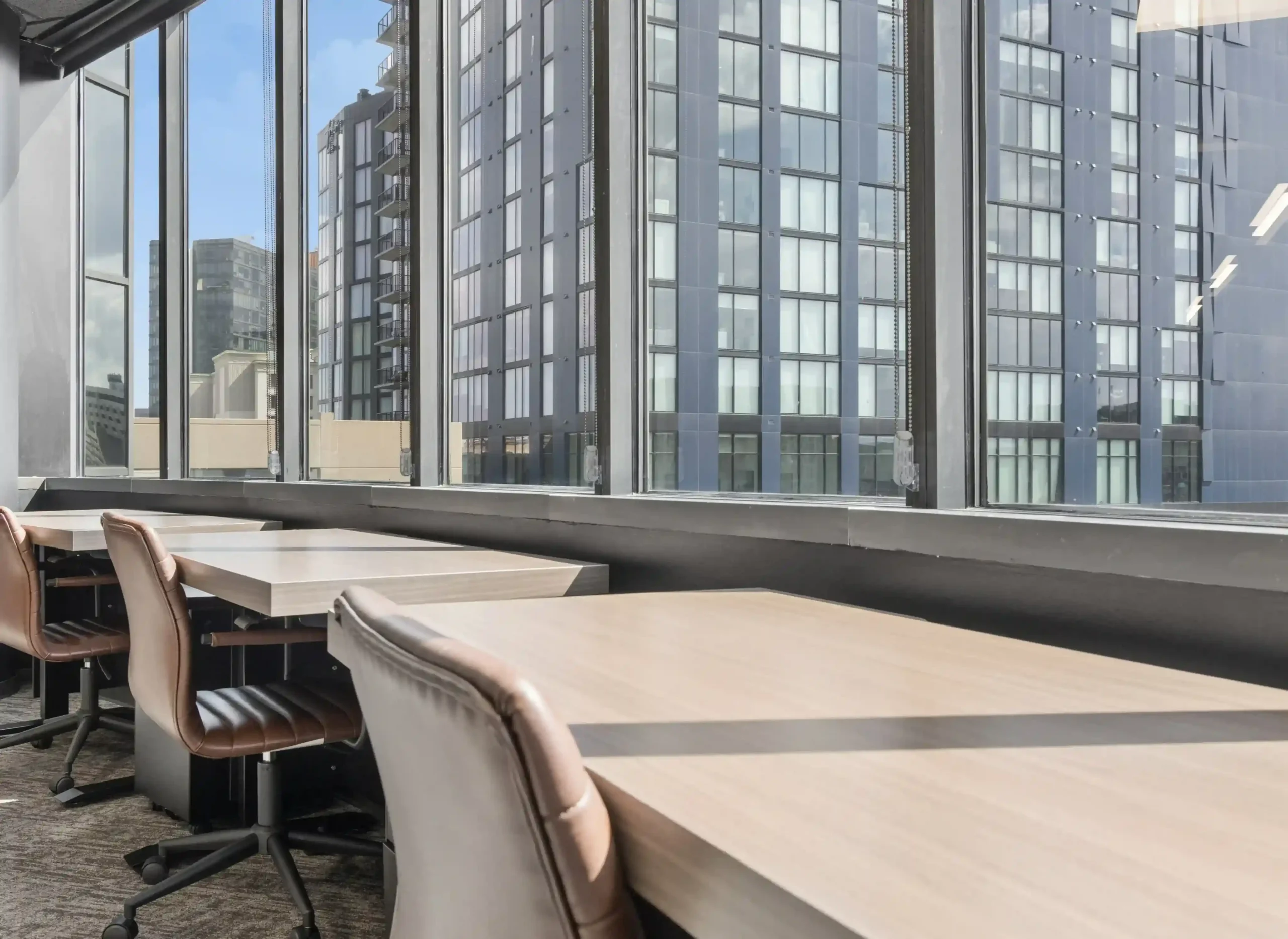 Conference table by skyline windows at Lucid Private Offices Nashville